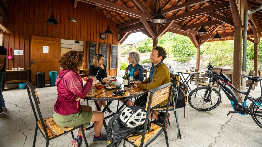Group of friends tasting wine at the "Quai des Hatles", along the Dolce Via, in autumn