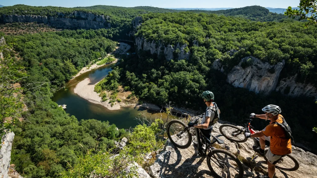 The Ardeche Great Mountain Bike Route - Two men on mountain bikes above the Chassezac Gorges, in summer