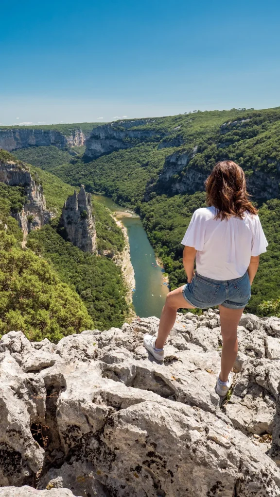 Woman observing the landscape of the Ardèche gorges, in summer, with the "Cathedral Rock"