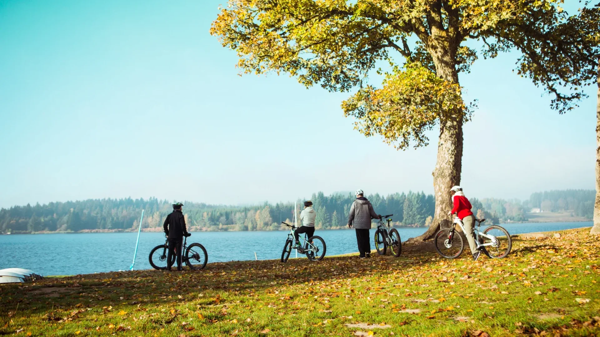 Group of cyclists near Devesset Lake in autumn