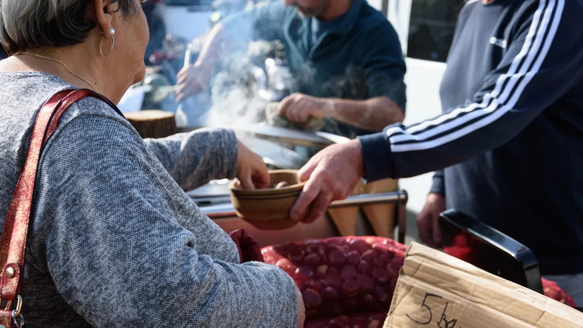 Woman picking a roasted chestnut