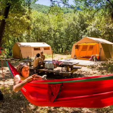 Femme se détendant dans un hamac lors d'un bivouac dans les Gorges de l'Ardèche, en été